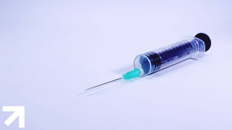 injeção meramente ilustrativa com pílulas azuis dentro da seringa